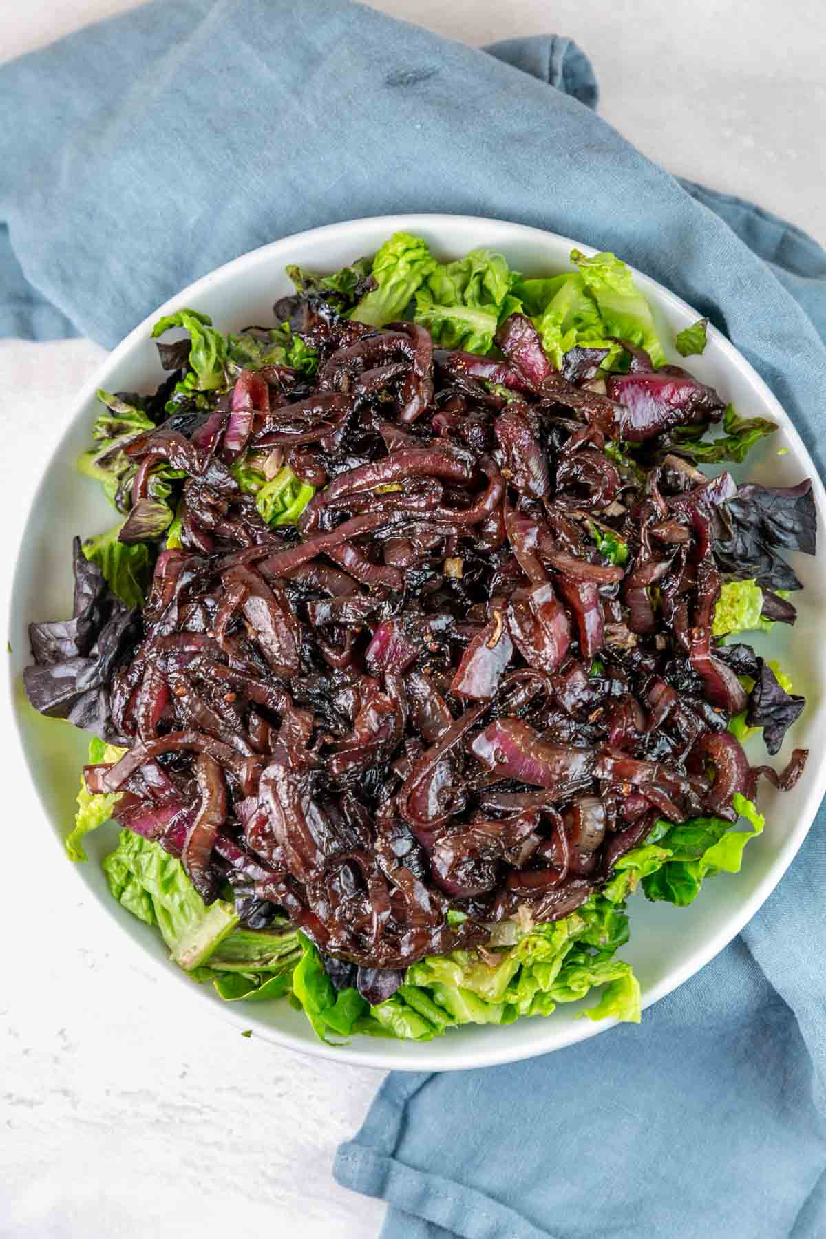 overhead view of a salad covered with jammy caramelized onions