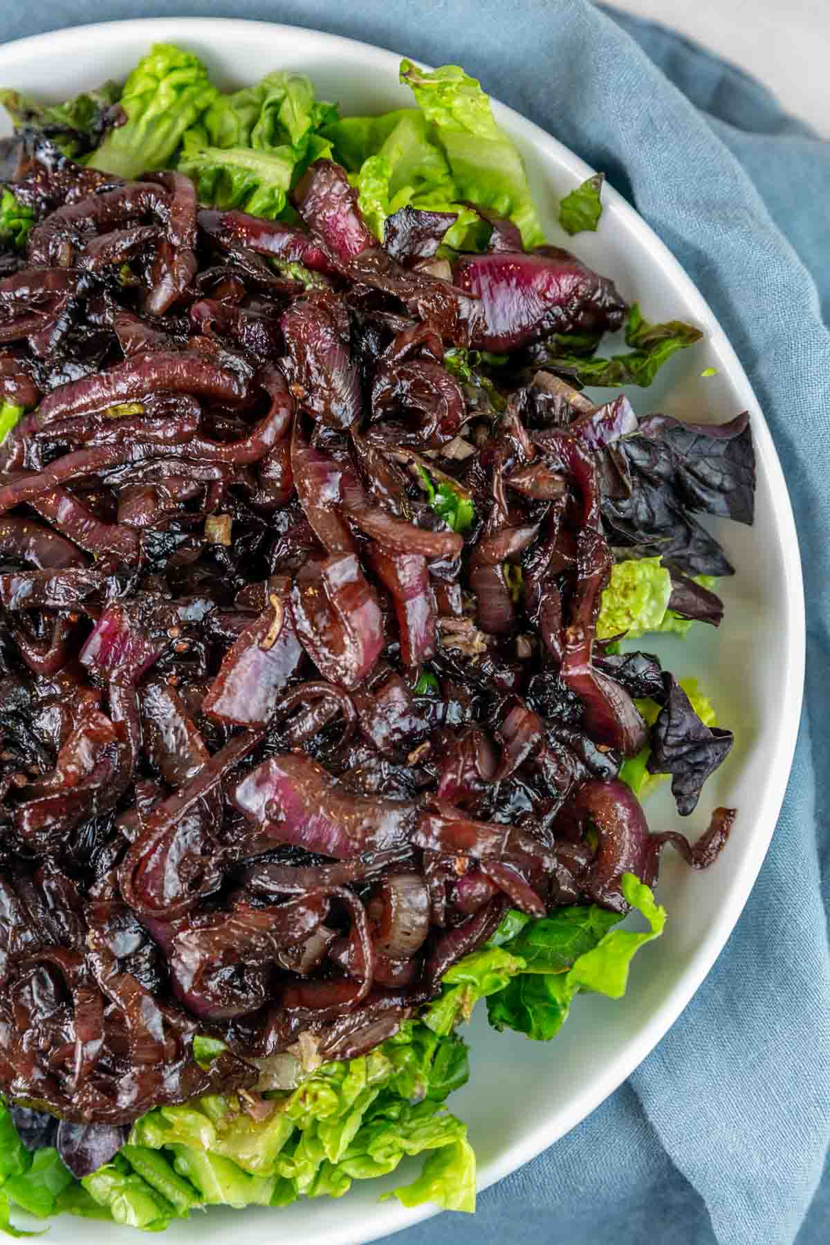 caramelized balsamic red onions on a bed of bright green lettuce