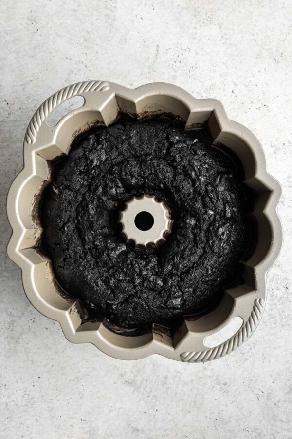 dark chocolate cake baked in a metal bundt pan