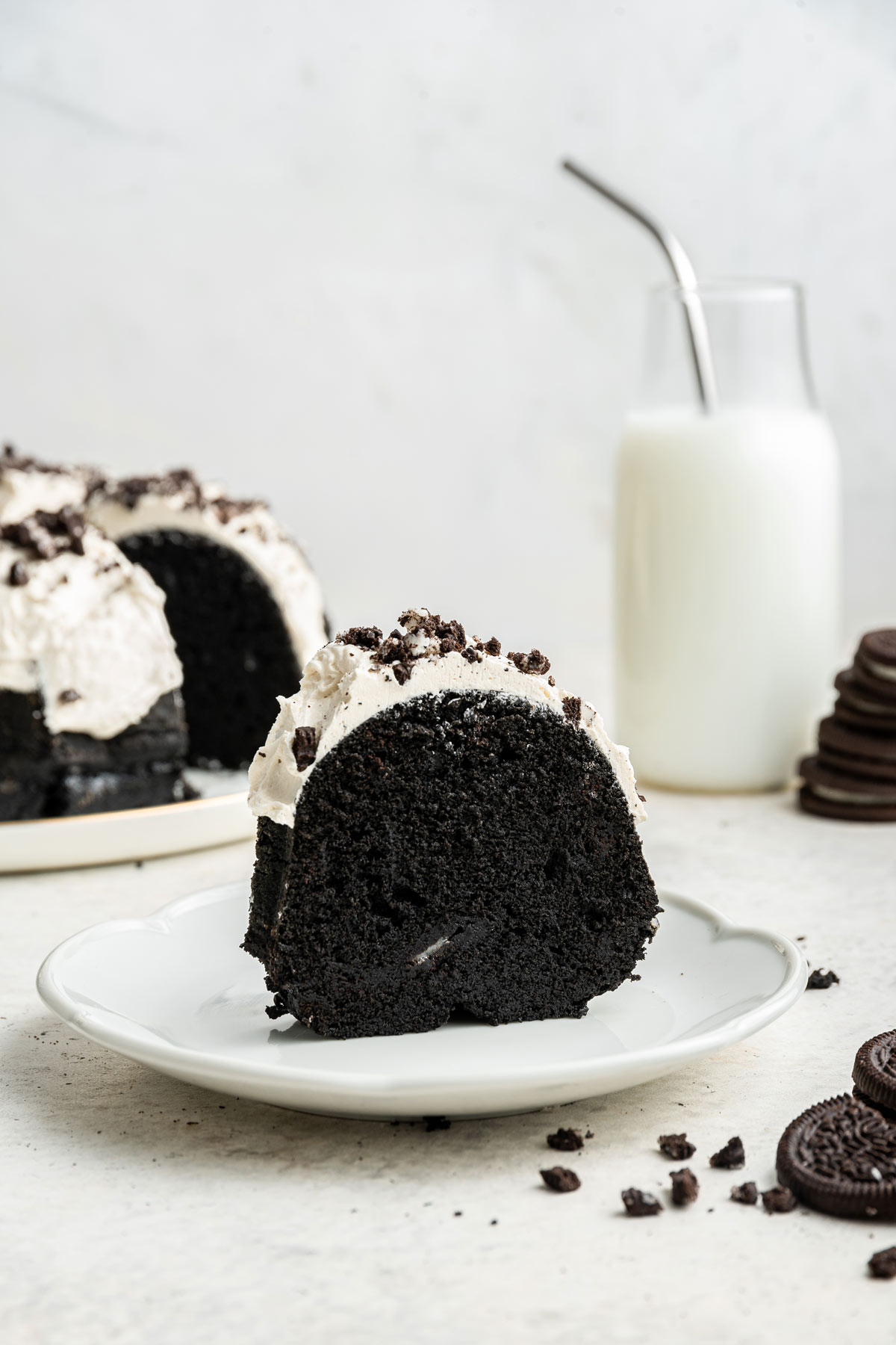 slice of oreo bundt cake on a decorative dessert plate