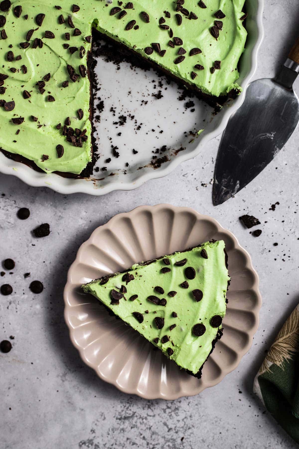 slice of pie on a dessert plate next to a cake server