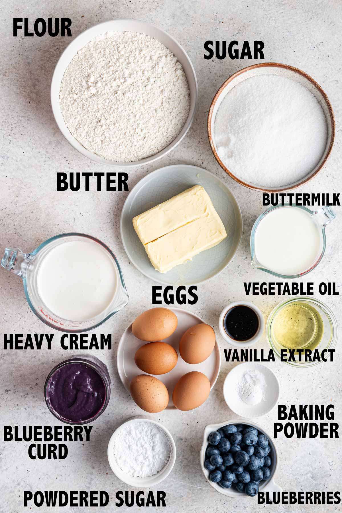 overhead view of all the ingredients used to make a blueberry cake filled with blueberry curd