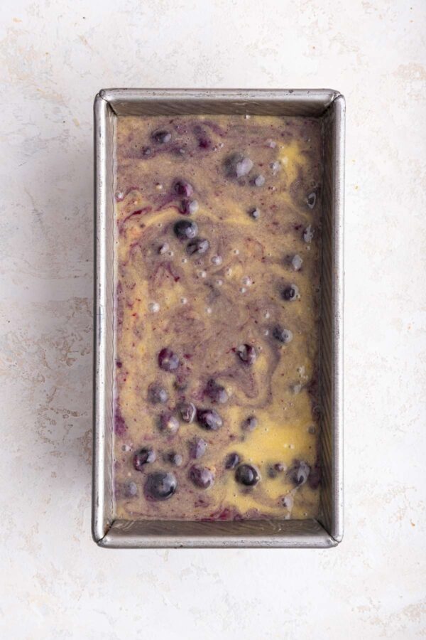 swirled blueberry pie bread batter in a metal loaf pan