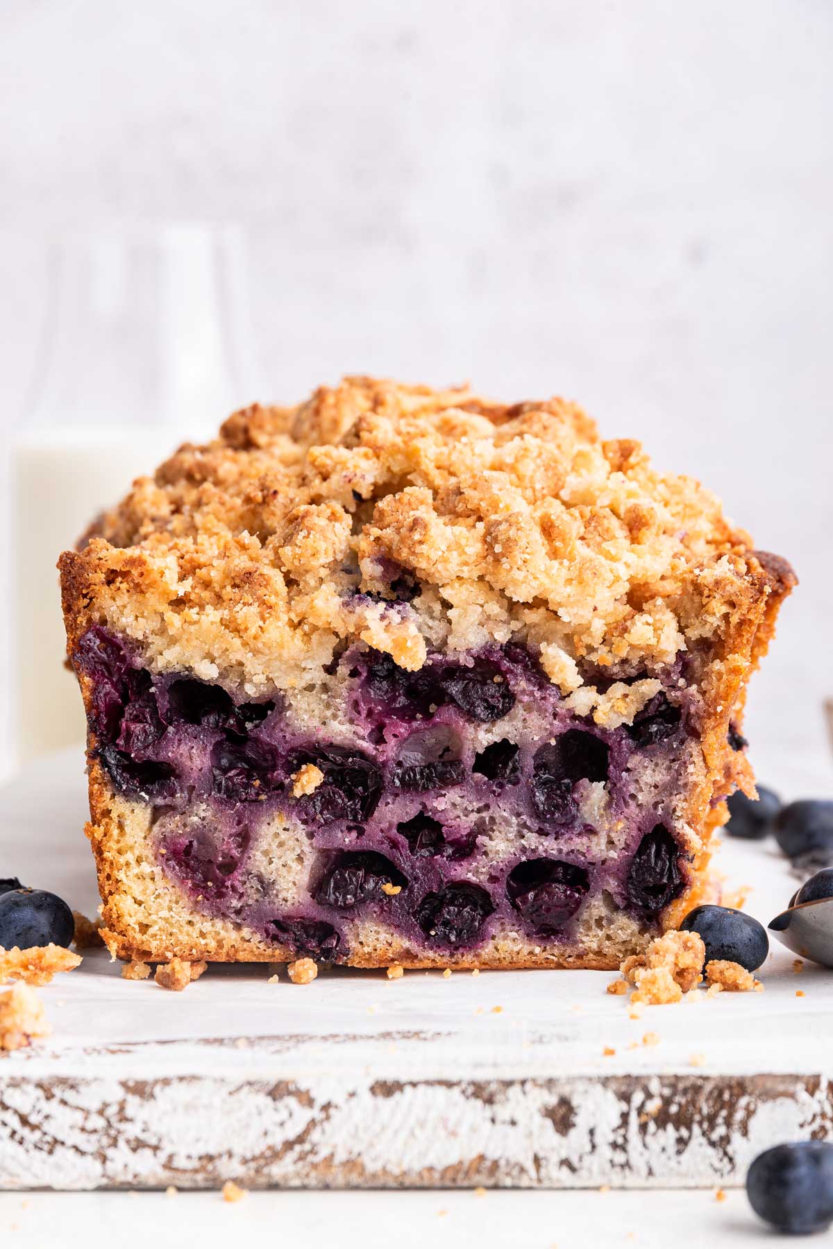 side view of a loaf of blueberry bread covered with an almond streusel