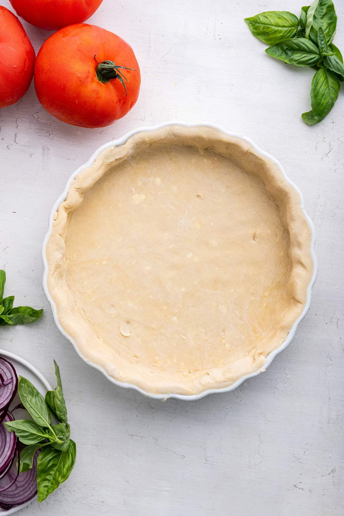 unbaked pie dough pressed into a ceramic pie plate