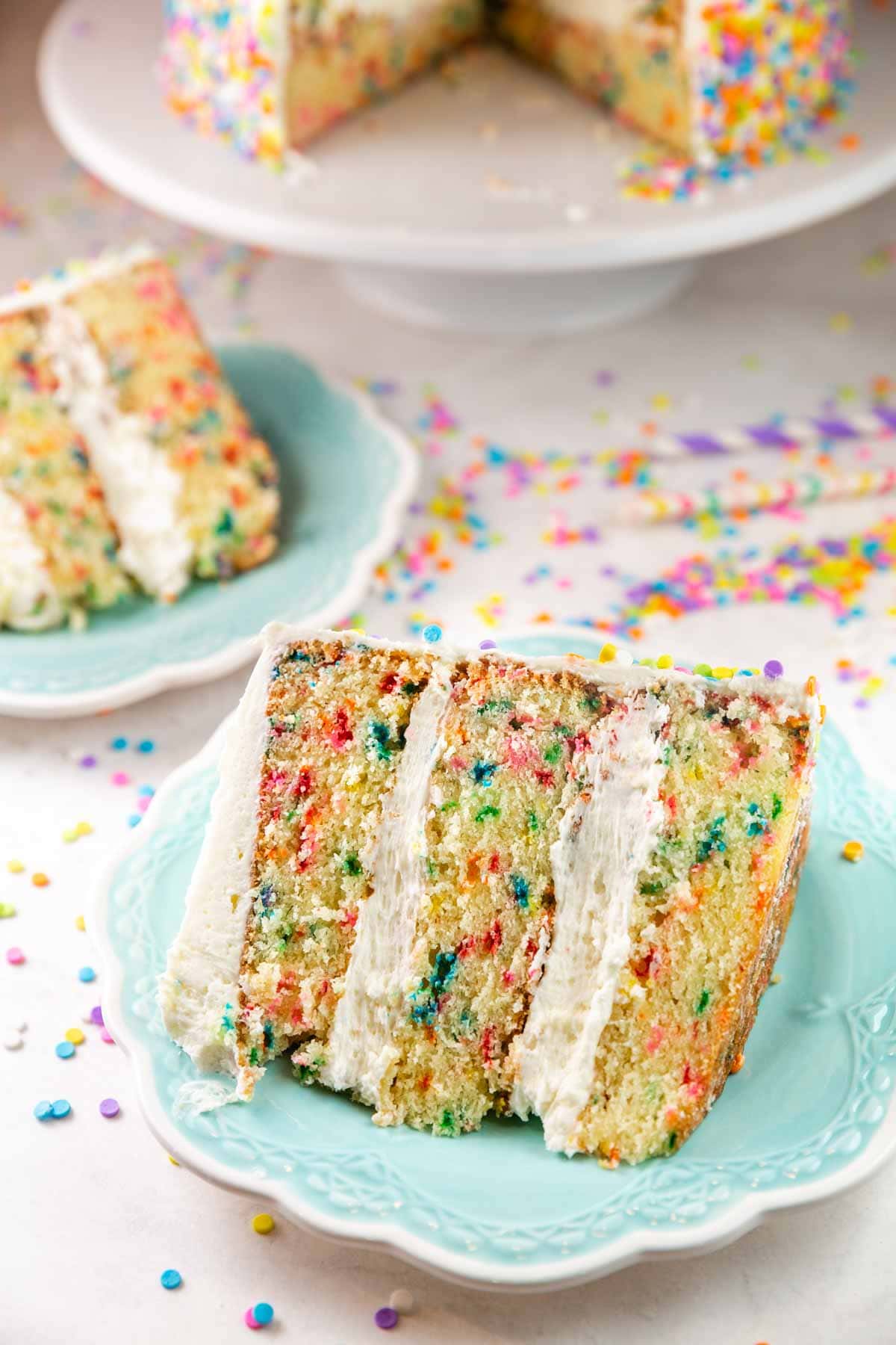 two big slices of funfetti cake surrounded by sprinkles