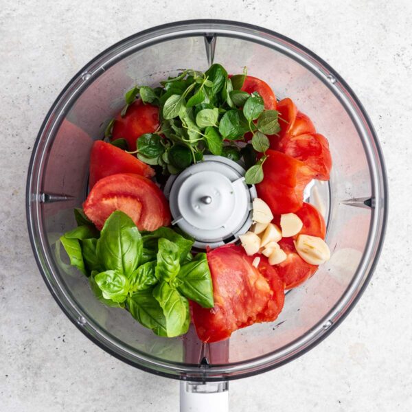 tomatoes, garlic, and herbs in a  food processor