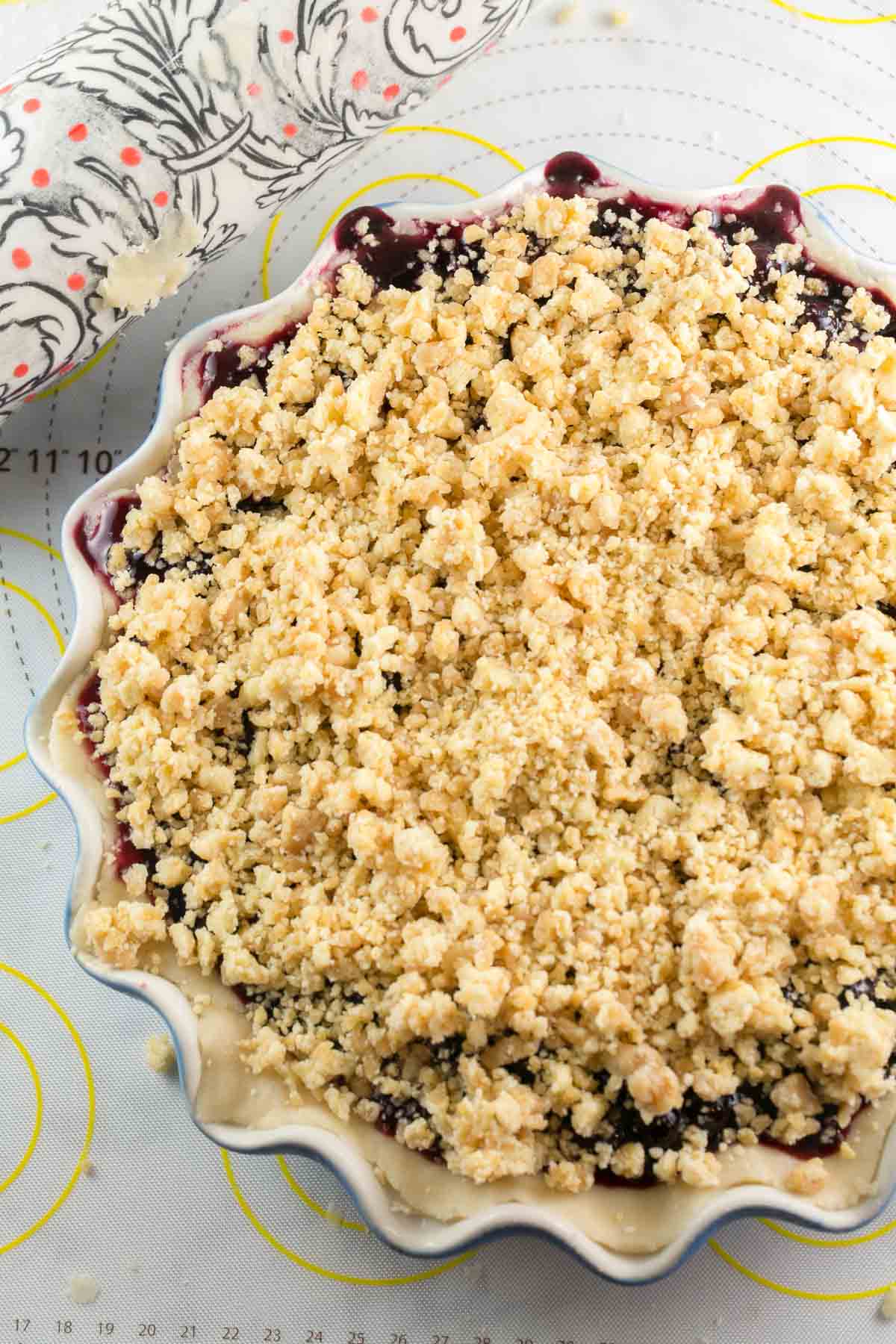 unbaked blueberry pie topped with a buttery almond crumble
