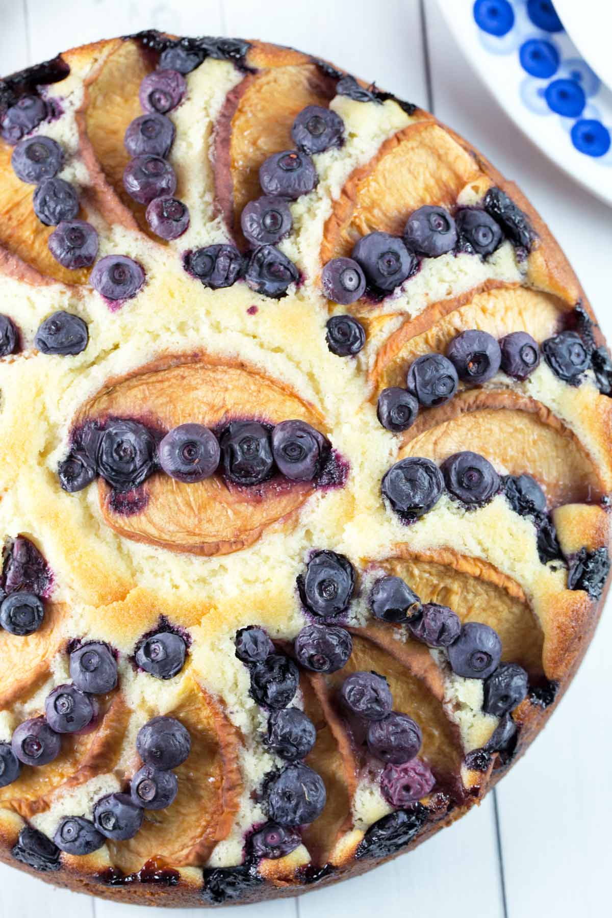 freshly baked coffee cake covered with blueberries and peaches