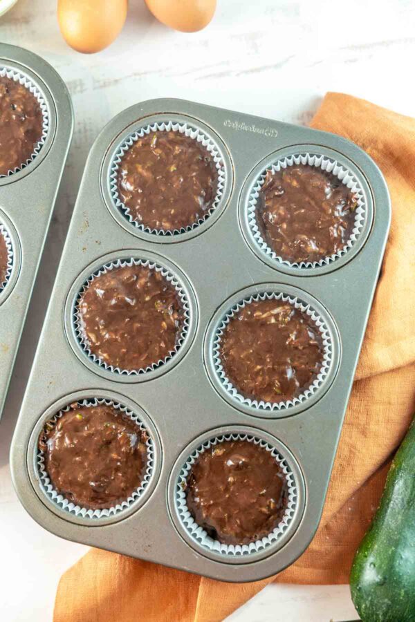 6 well muffin tin filled with unbaked muffin batter