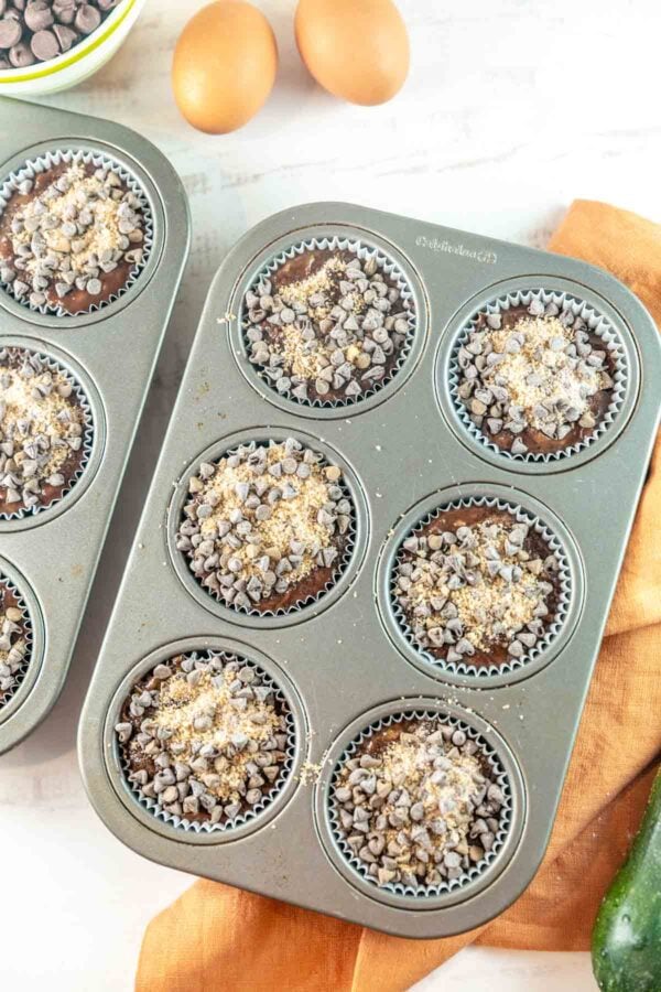 unbaked muffins covered with a sugary chocolate chip streusel