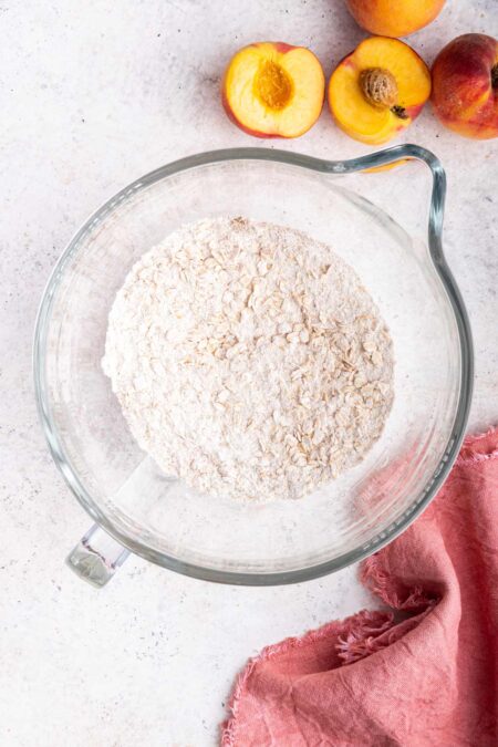 ingredients to make the crust for pie bars in a glass mixing bowl