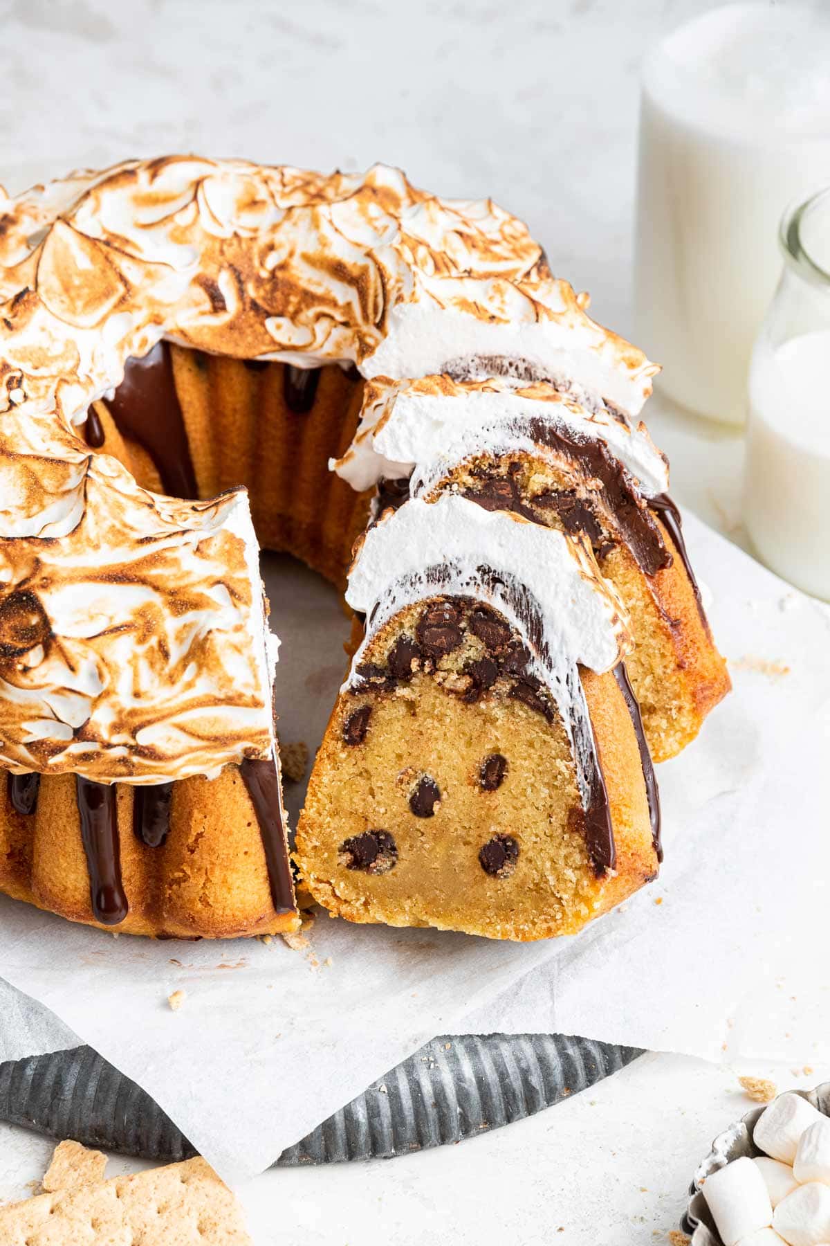 s'mores bundt cake filled with chocolate chips cut into slices