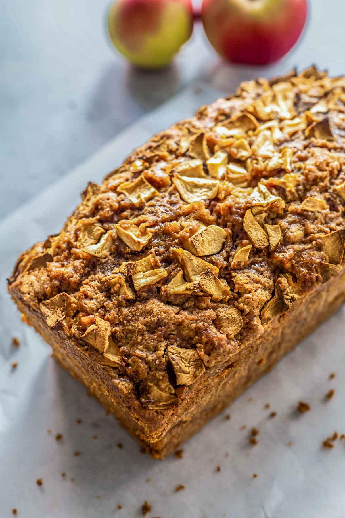 side view of an uncut loaf of apple bread.