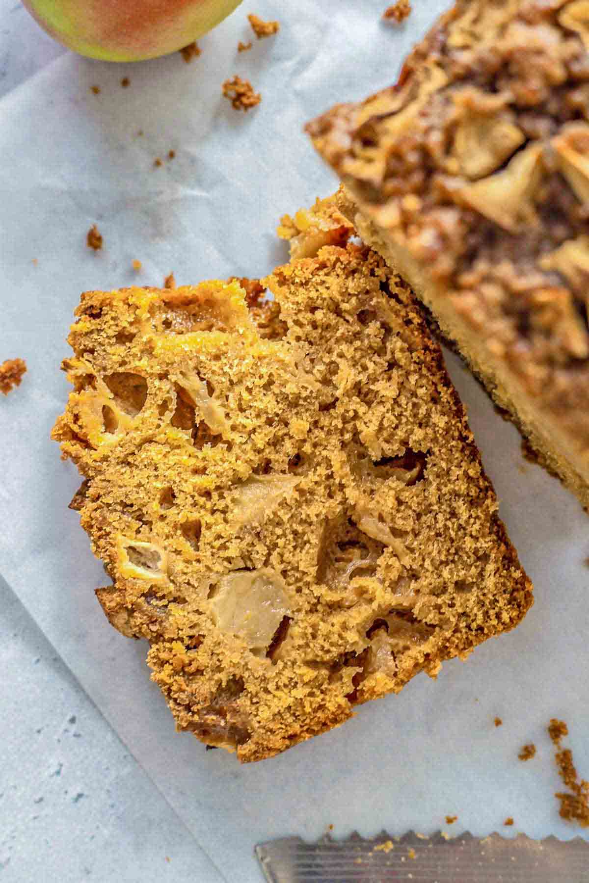 slice of apple bread showing chunks of apples baked within the bread.