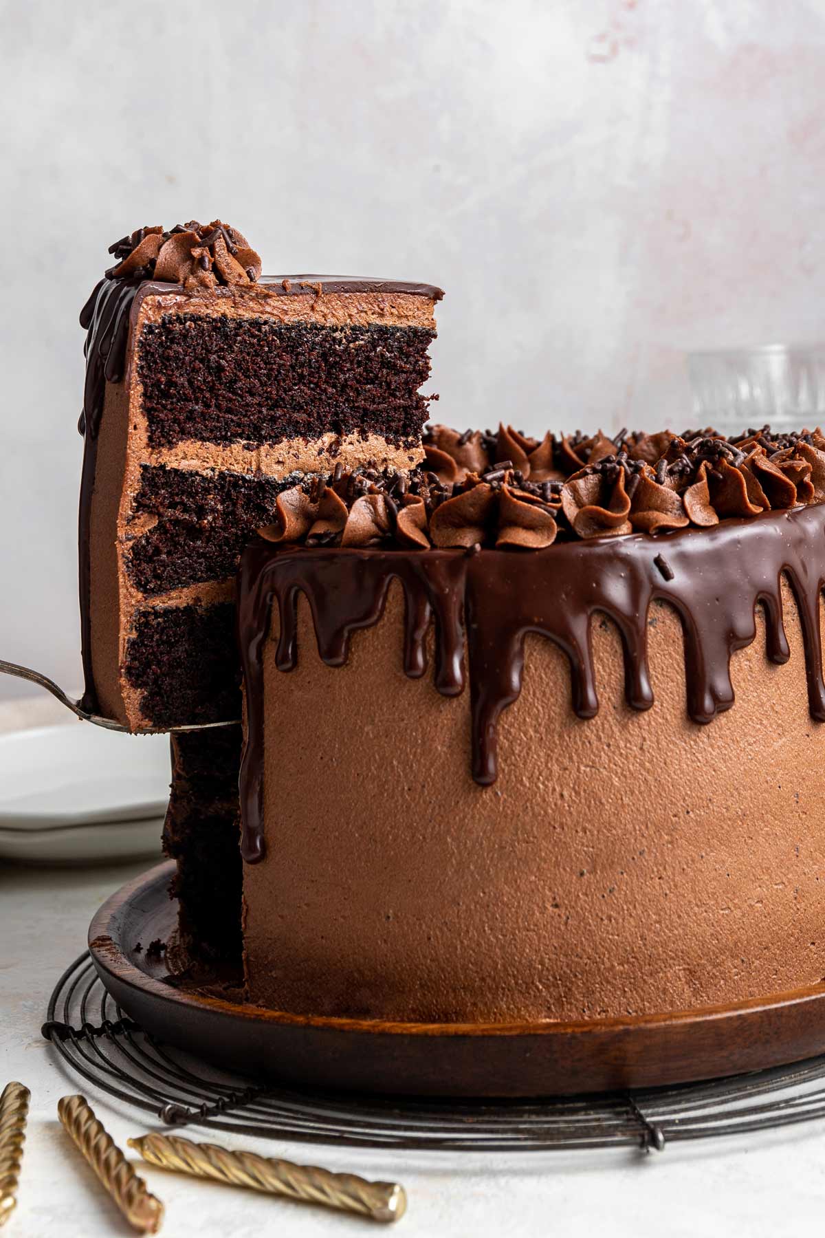 one slice of chocolate cake on a spatula being lifted from the rest of the cake.