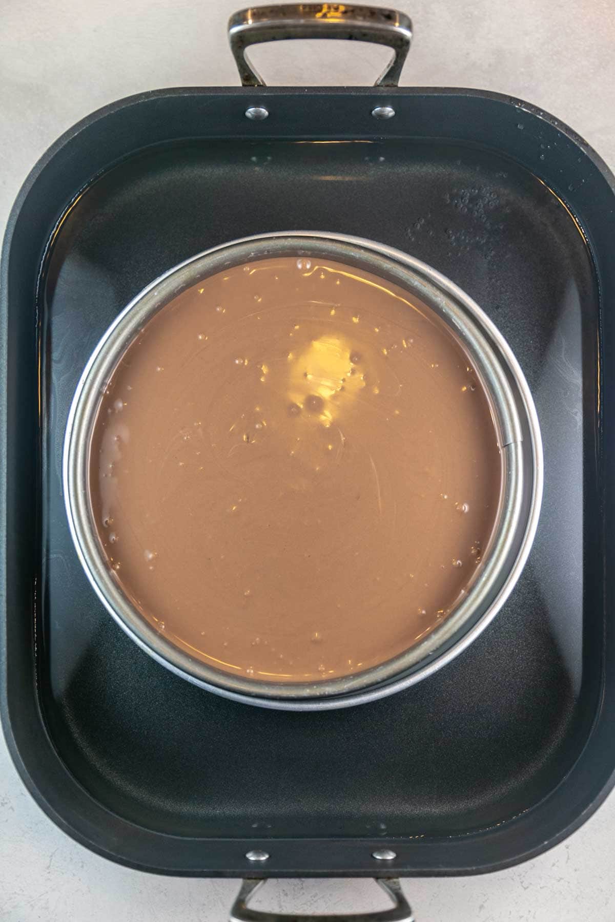 cheesecake in a springform pan in a water bath