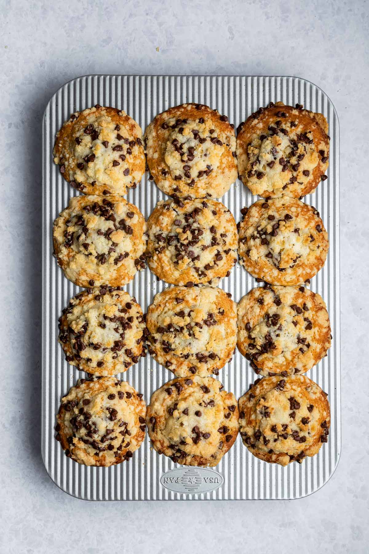 freshly baked muffins in a muffin tin with giant domed tops.