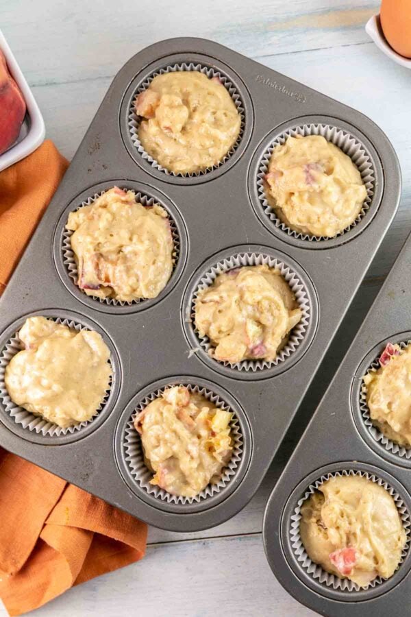 Muffin batter in muffin tins before being baked. 