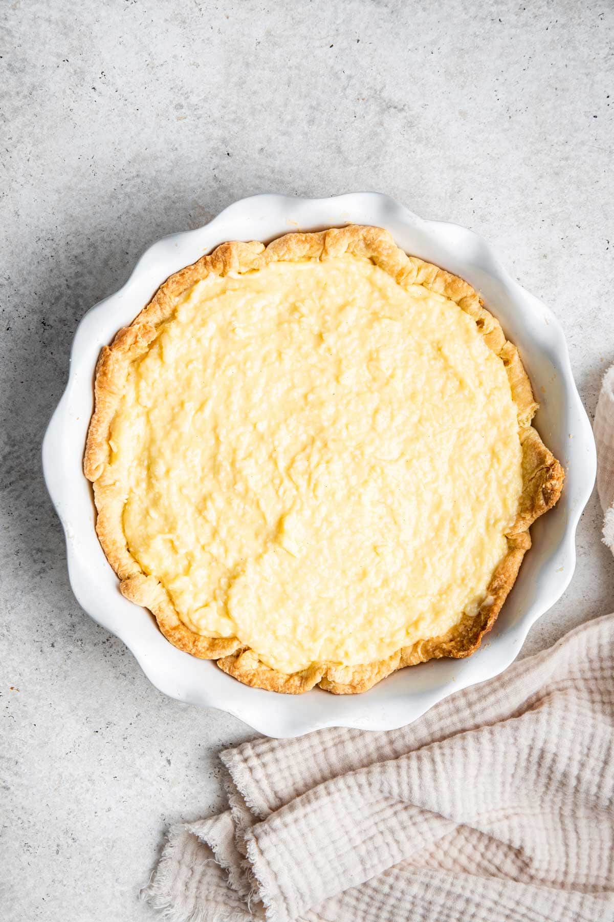 homemade coconut custard poured into a baked pie crust.