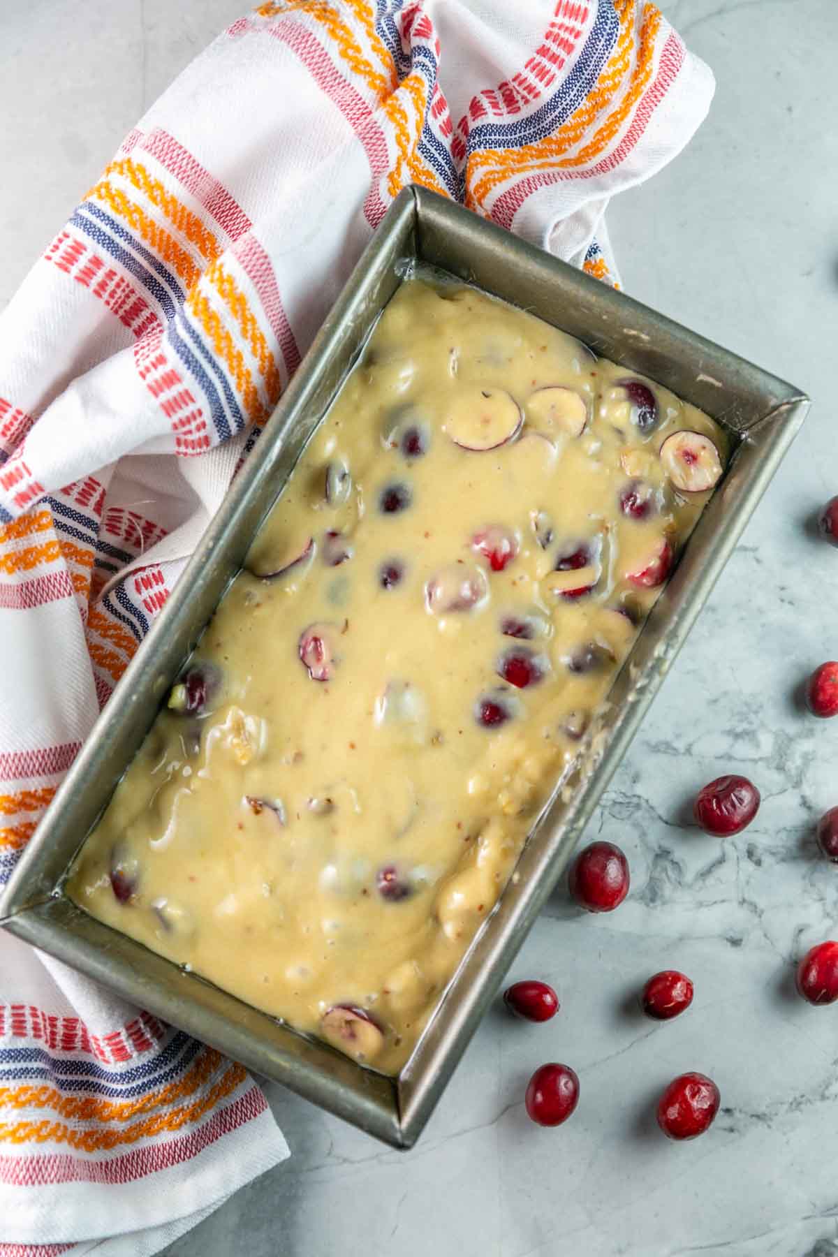 batter for cranberry bread poured into a loaf pan.