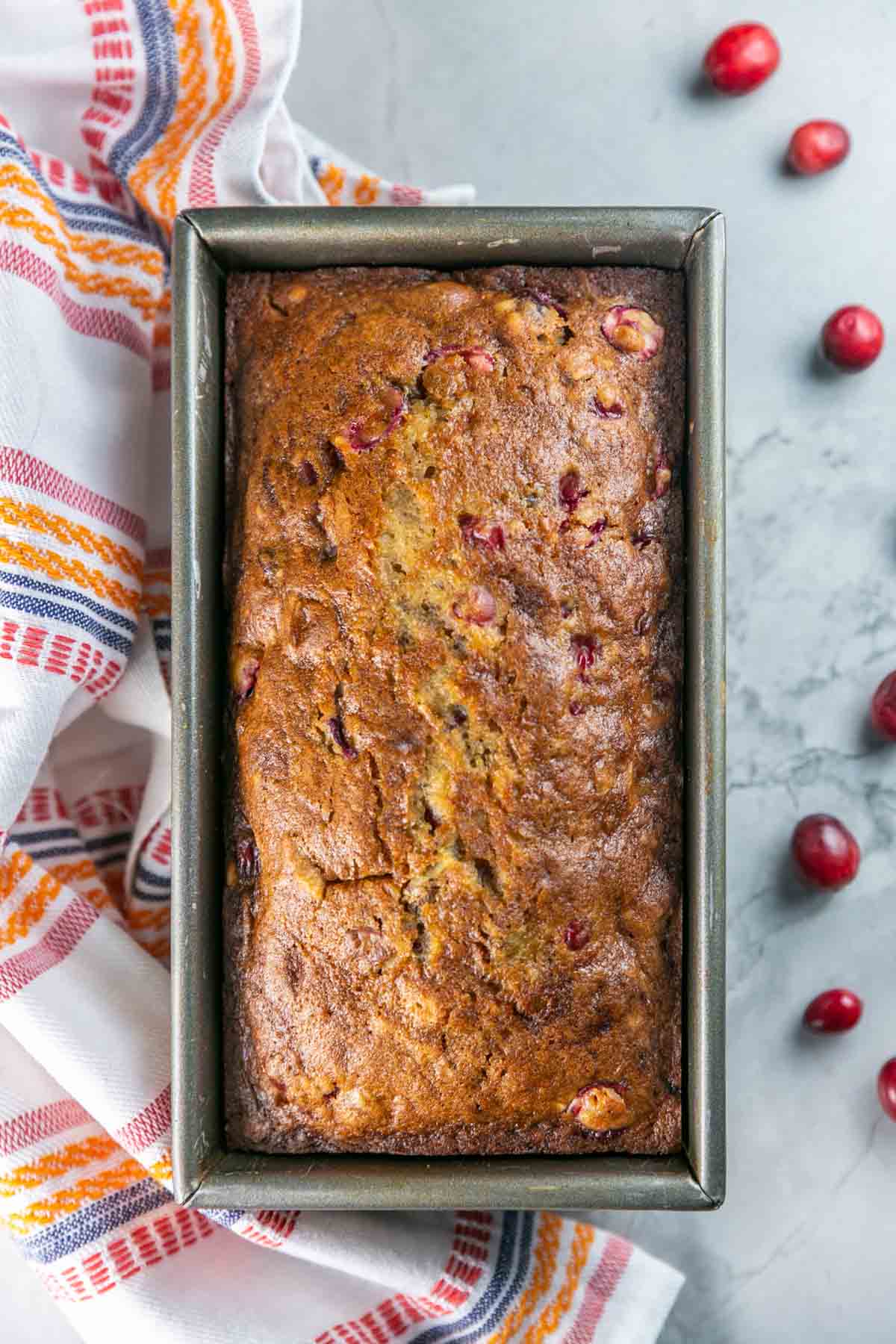 freshly baked cranberry bread still in the loaf pan.