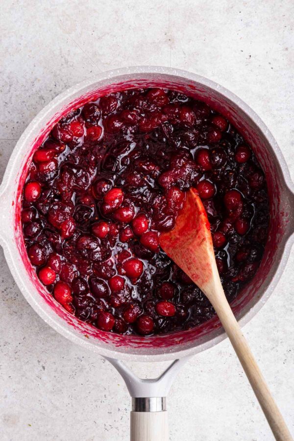 saucepan filled with cooked down cranberries and orange zest.
