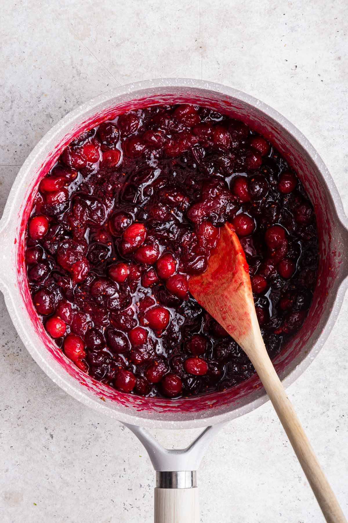cooked down cranberries and sugar in a saucepan.