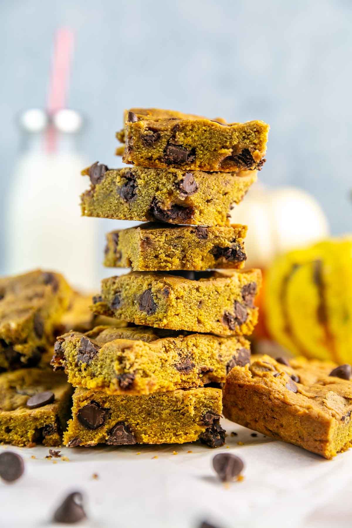 vertical stack of thick and chewy chocolate chip pumpkin bars.