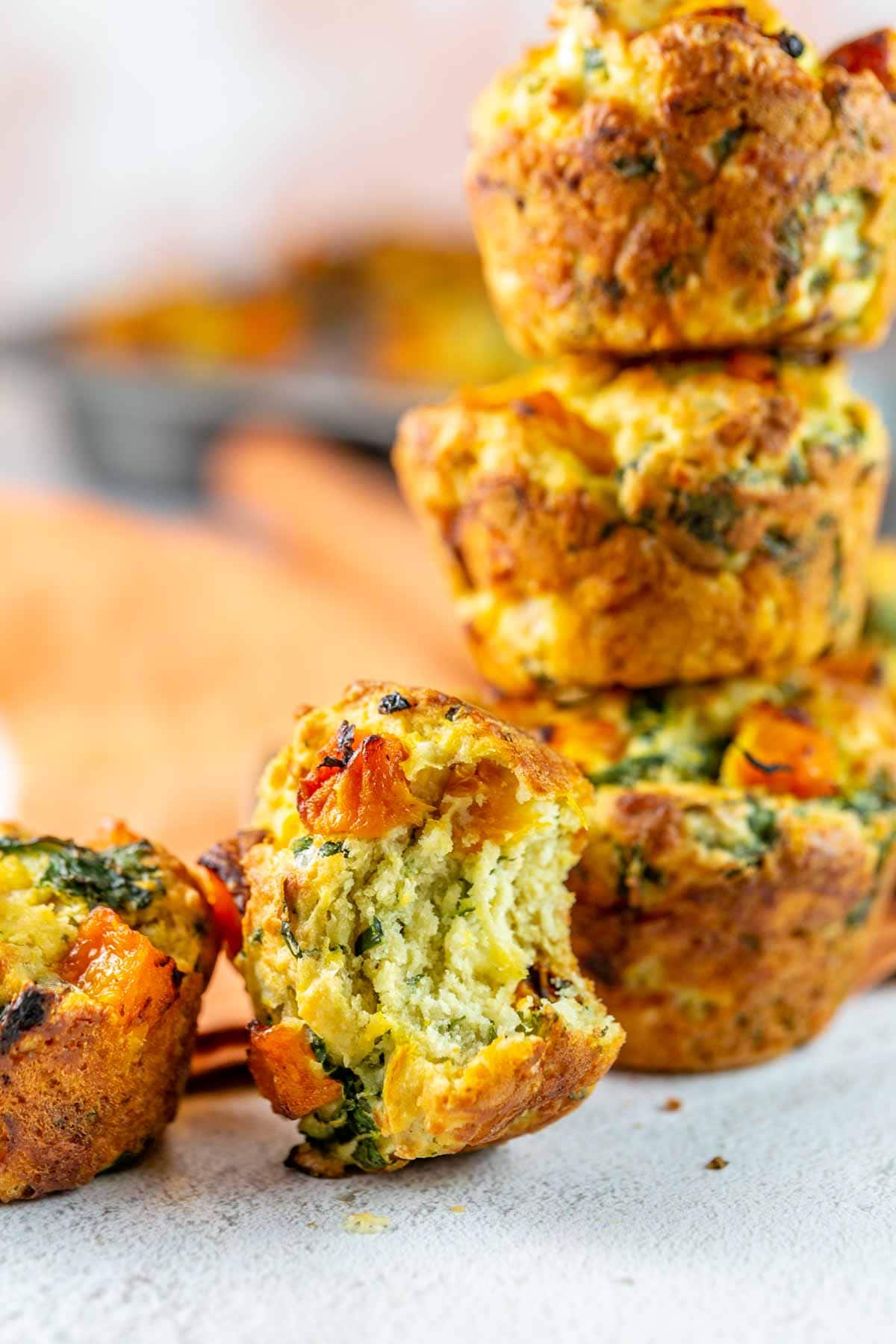 savory muffin with one bite taken out of it.