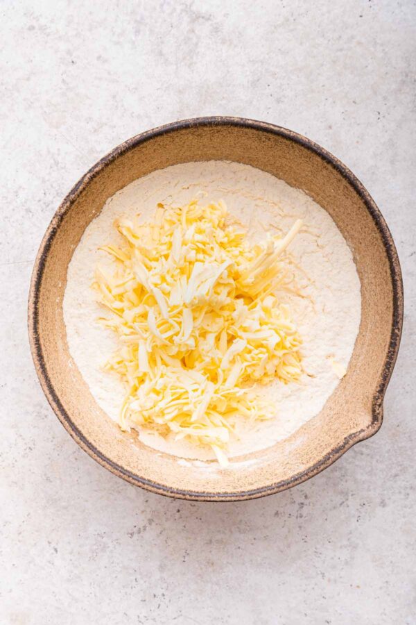 frozen grated butter in a mixing bowl.