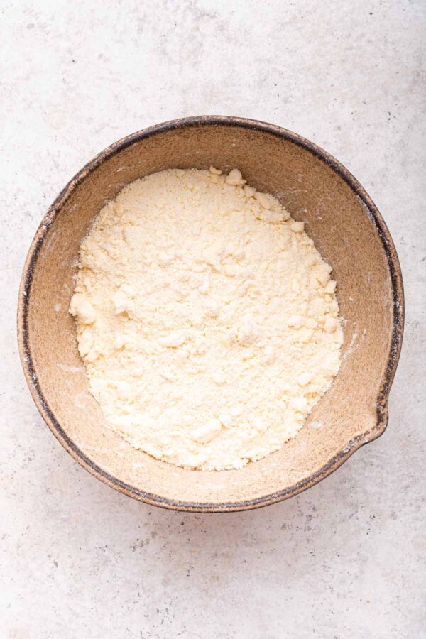 butter cut into a flour and sugar mixture.