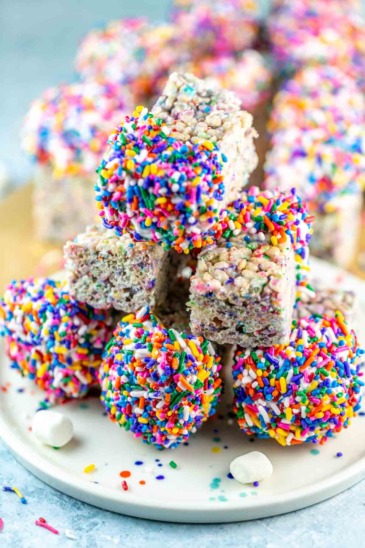 six rectangular rice krispie treats covered in chocolate and sprinkles.