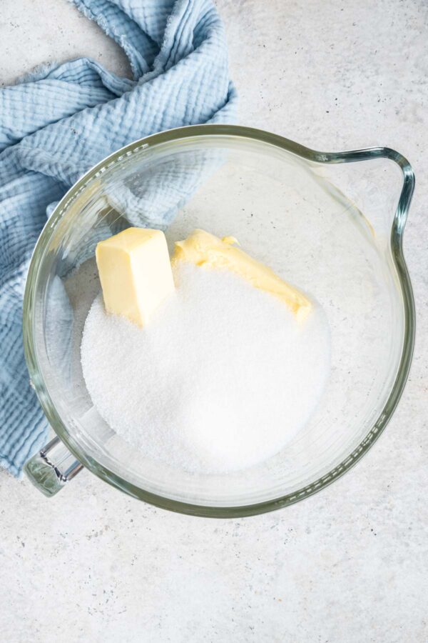 butter and sugar in a glass mixing bowl.