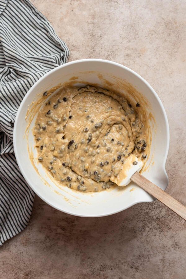 banana muffin batter in a white mixing bowl.