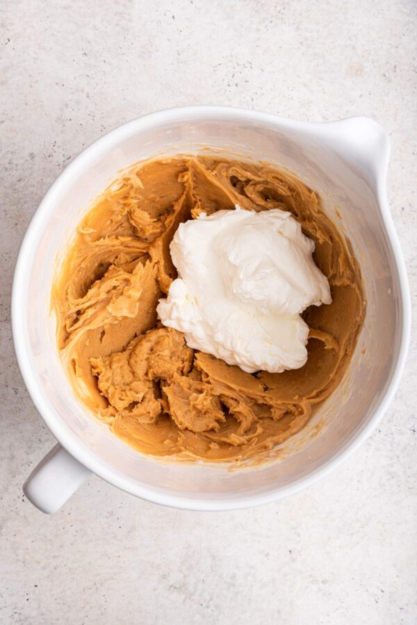 folding whipped cream into a peanut butter cream cheese mixture.