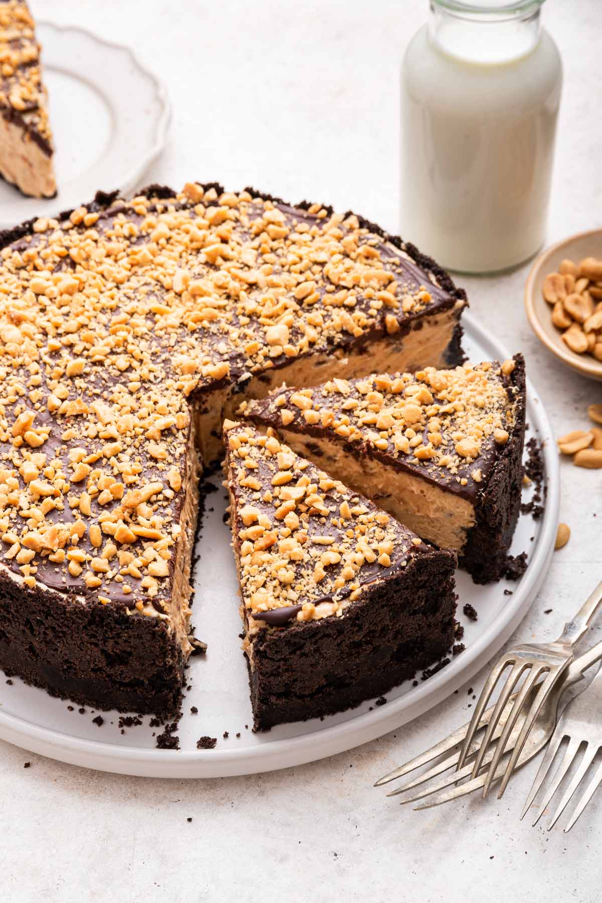 two slices removed from a cheesecake with an oreo cookie crust.