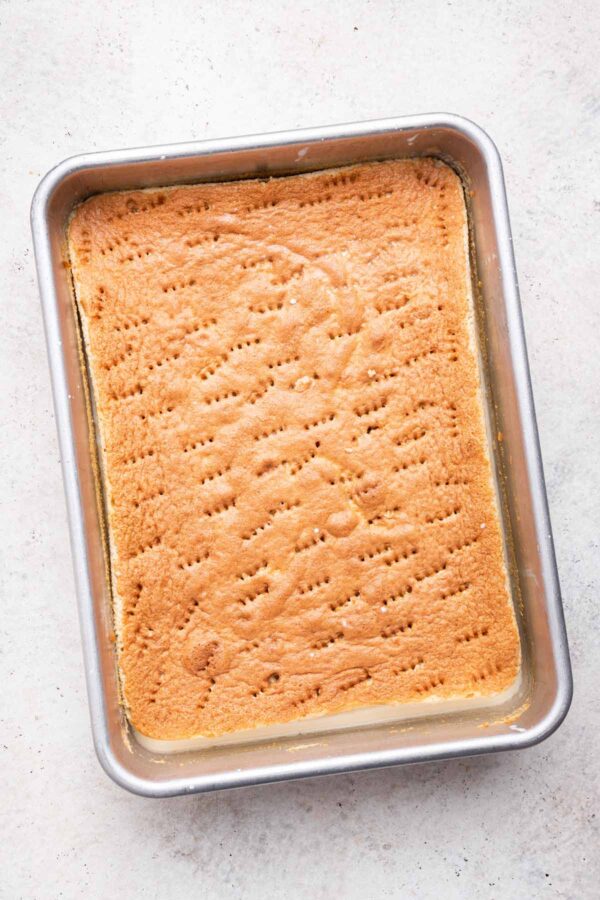 tres leches sponge cake soaking up the three milk mixture.