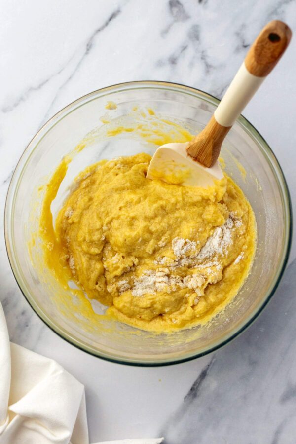 mixing together ingredients to make brown butter muffins.