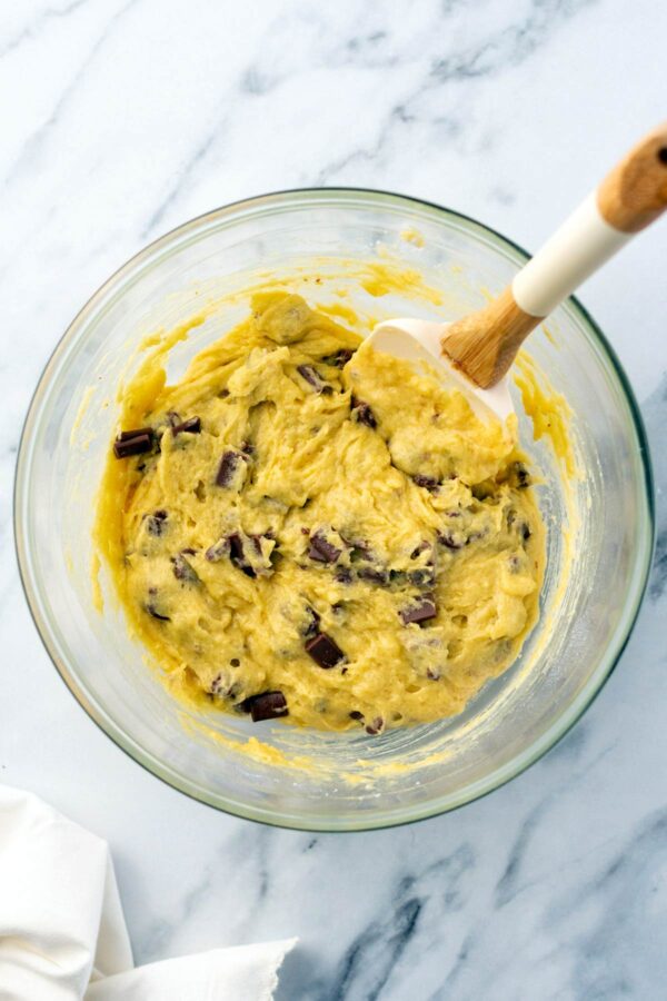 folding chocolate chunks into muffin batter.