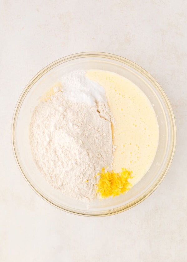 lemon cupcake batter with flour and lemon zest on top.
