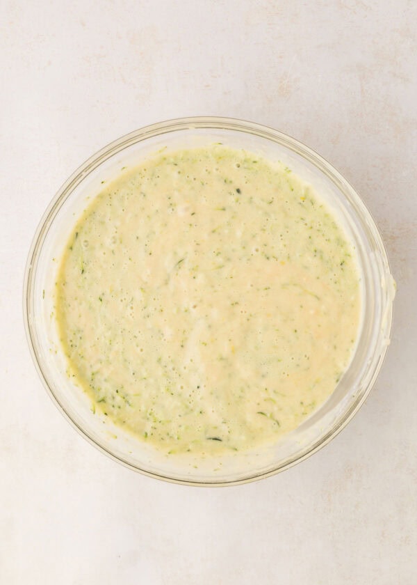 mixing bowl filled with batter for lemon zucchini cupcakes.