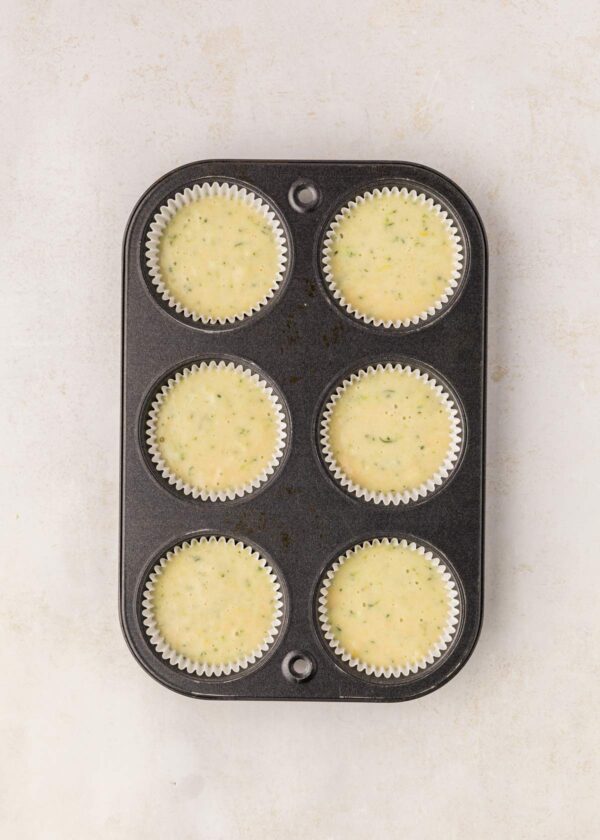 muffin tin filled with unbaked muffin batter.