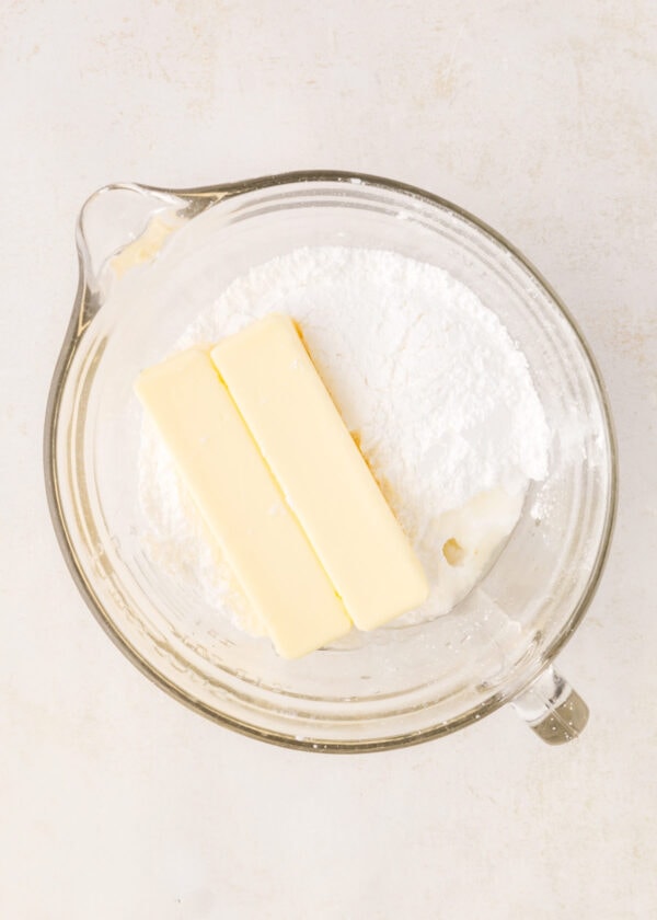 butter and powdered sugar in a mixing bowl.