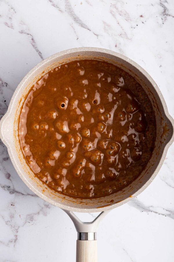 coooking homemade caramel sauce on the stovetop.
