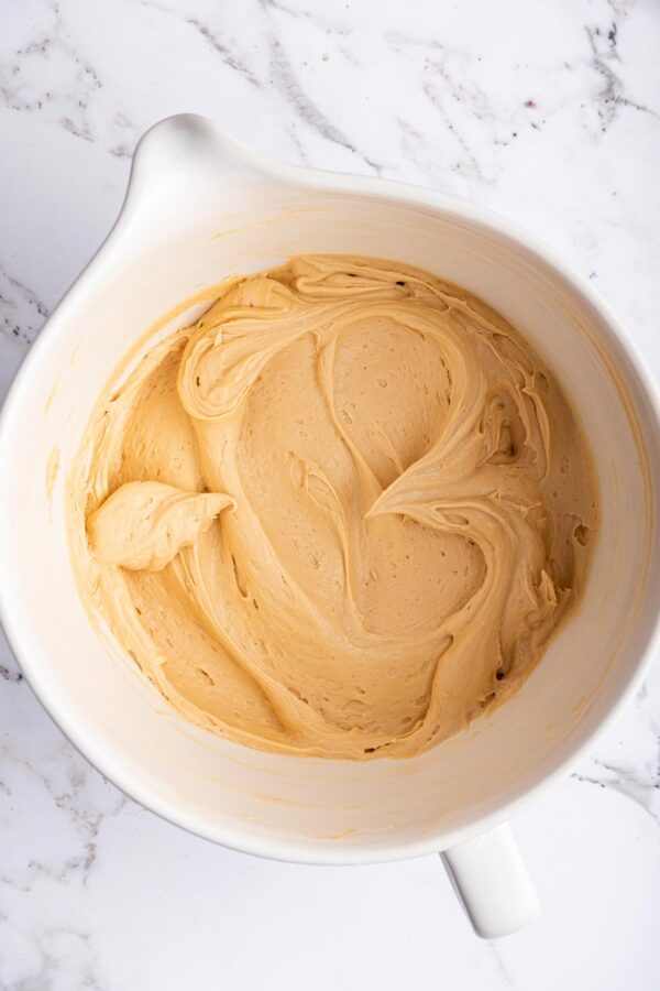 bowl filled with fluffy homemade salted caramel buttercream frosting.