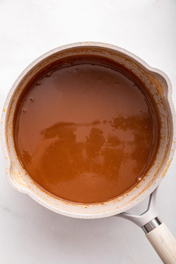 homemade caramel sauce cooking in a saucepan. 