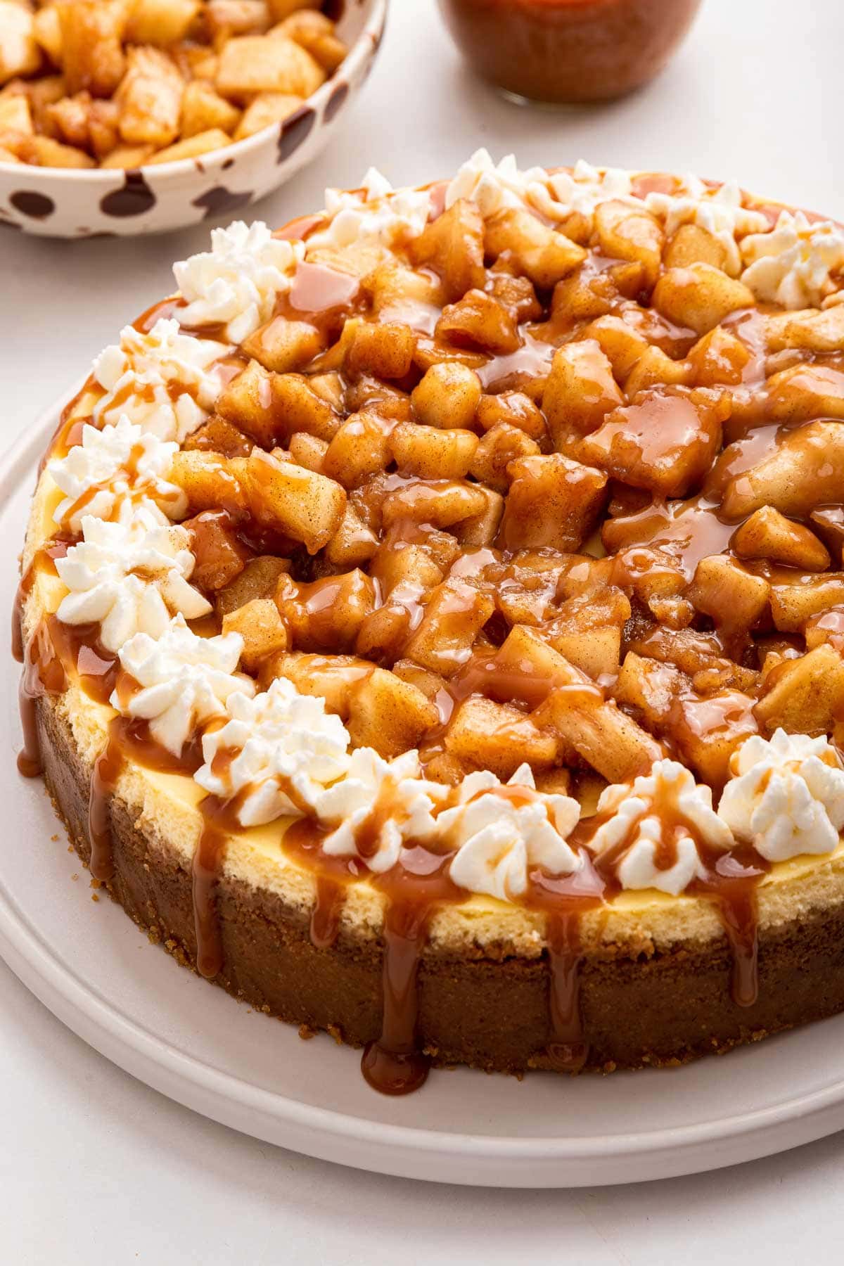 creamy cheesecake covered in apples and caramel sauce.
