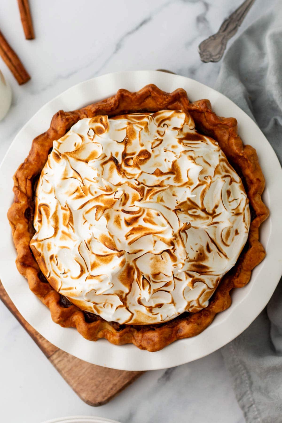 overhead view of a sweet potato pie with a fluffy pile of toasted meringue.