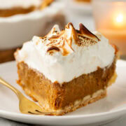 slice of sweet potato pie topped with a thick layer of toasted meringue.